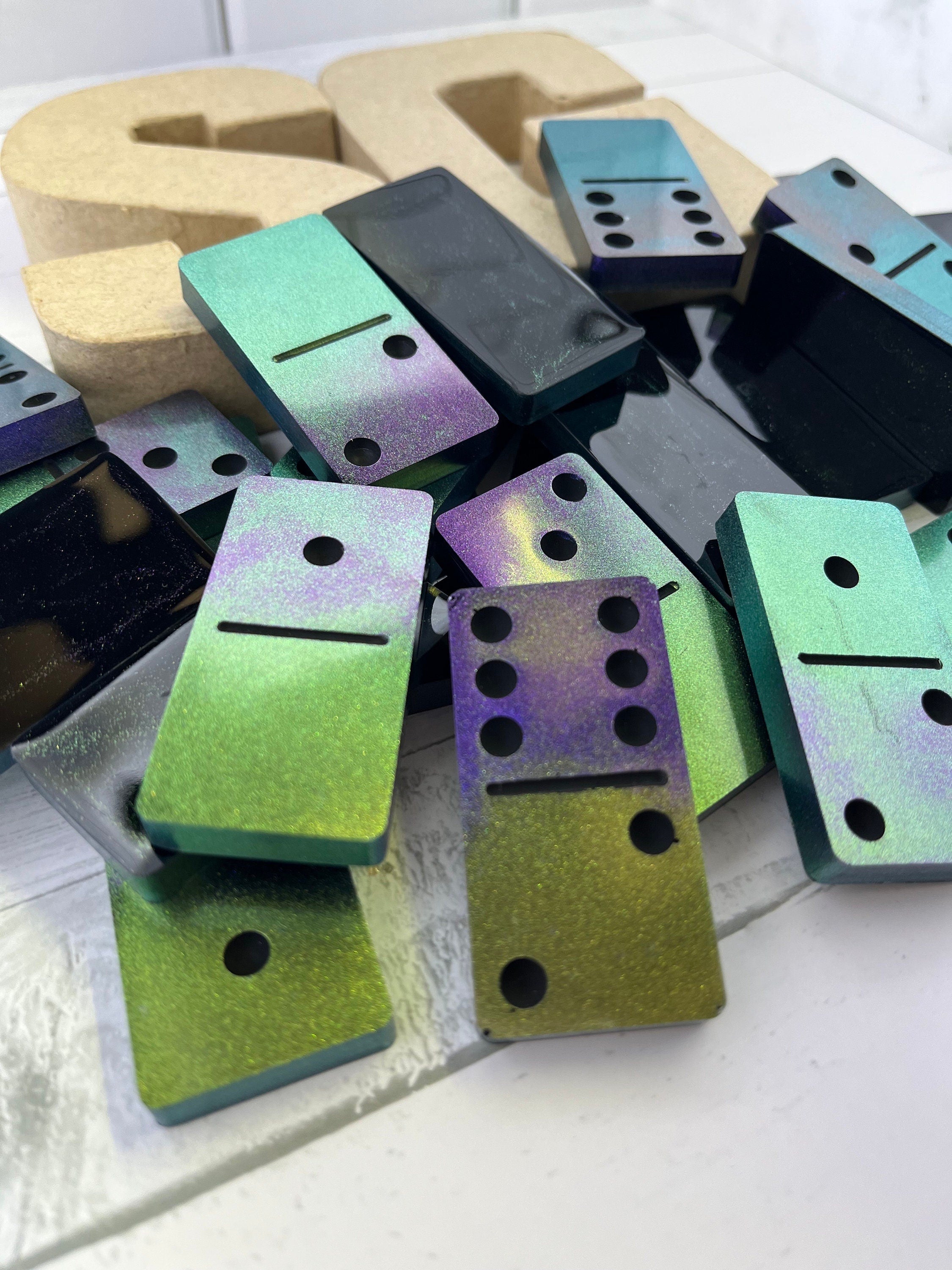 Black, purple, and green handmade resin Dominoes.