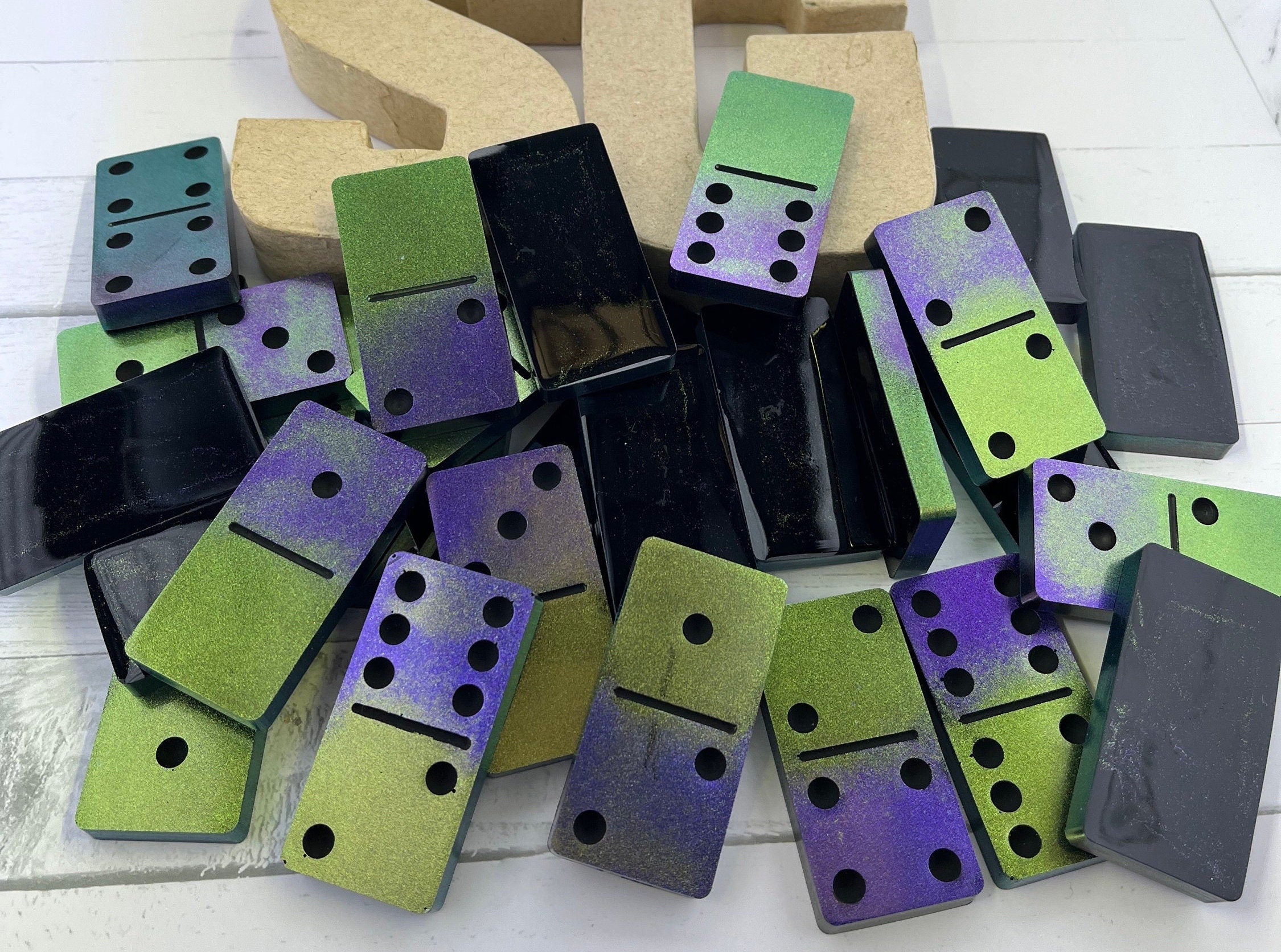 Black, purple, and green handmade resin Dominoes.