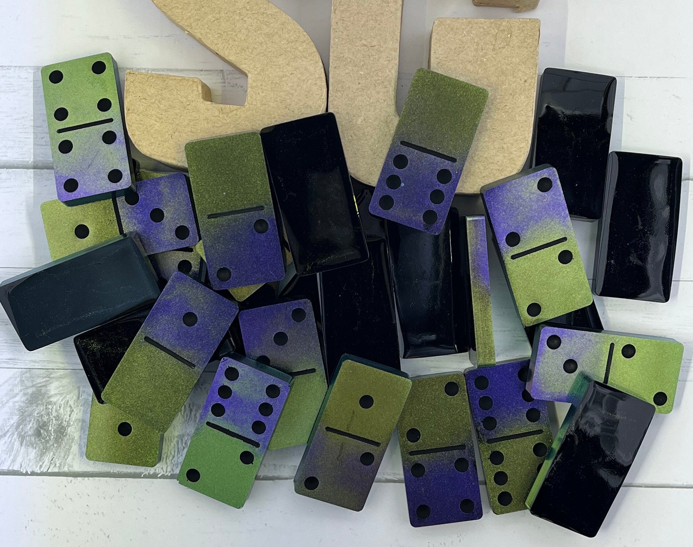 Black, purple, and green handmade resin Dominoes.