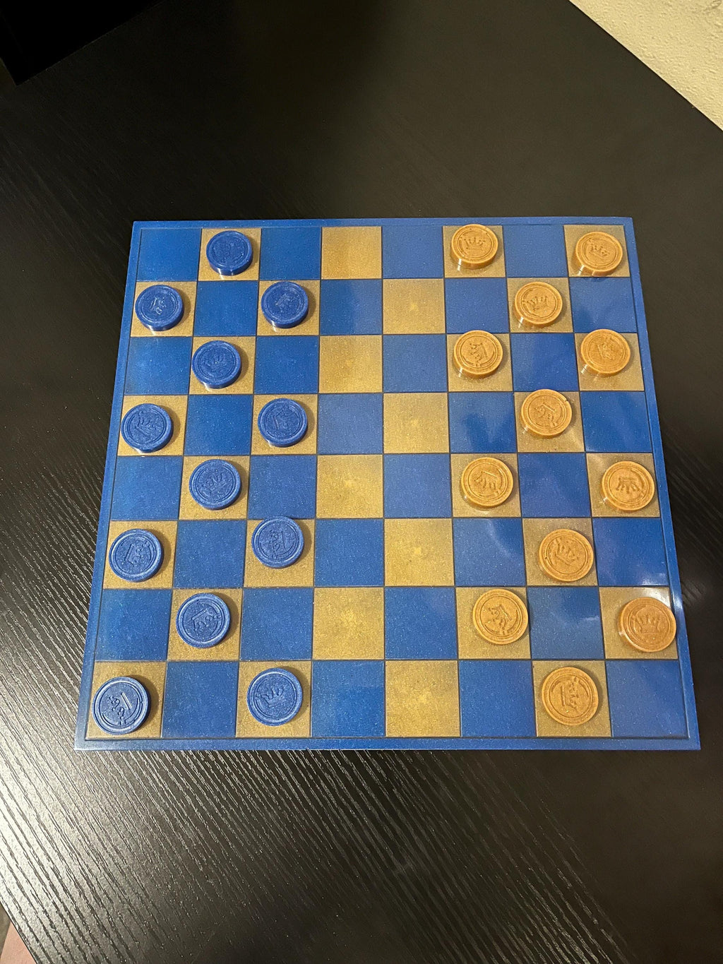 Blue and gold handmade resin checker set.