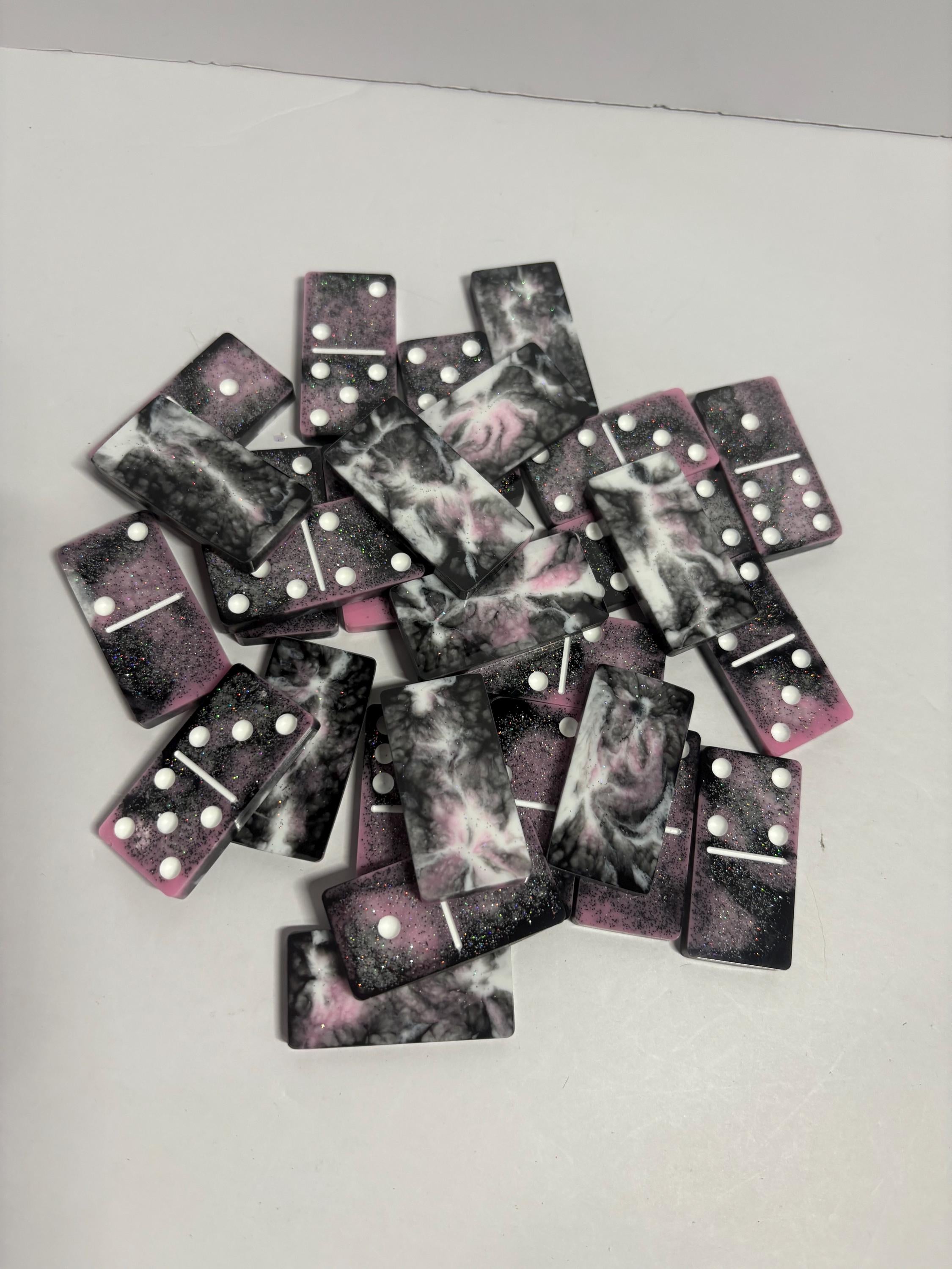 Black, pink, and white handmade resin Dominoes.