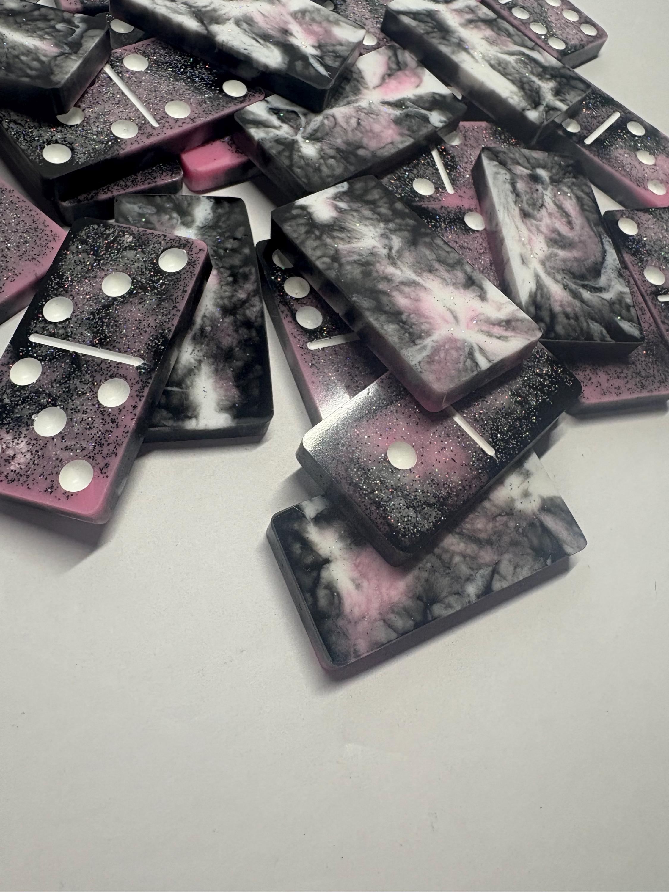 Black, pink, and white handmade resin Dominoes.