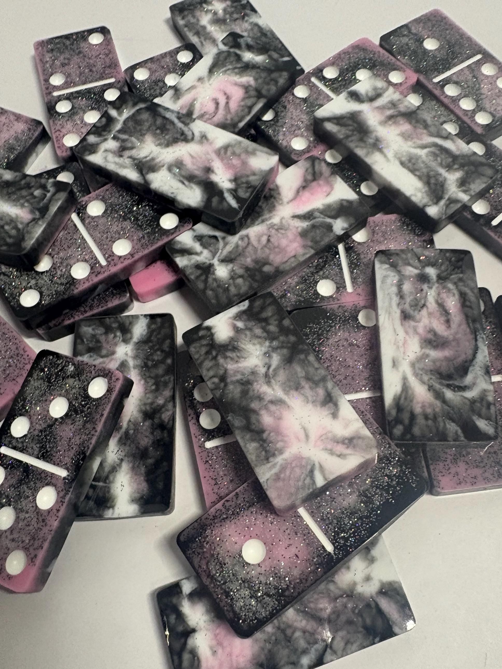 Black, pink, and white handmade resin Dominoes.